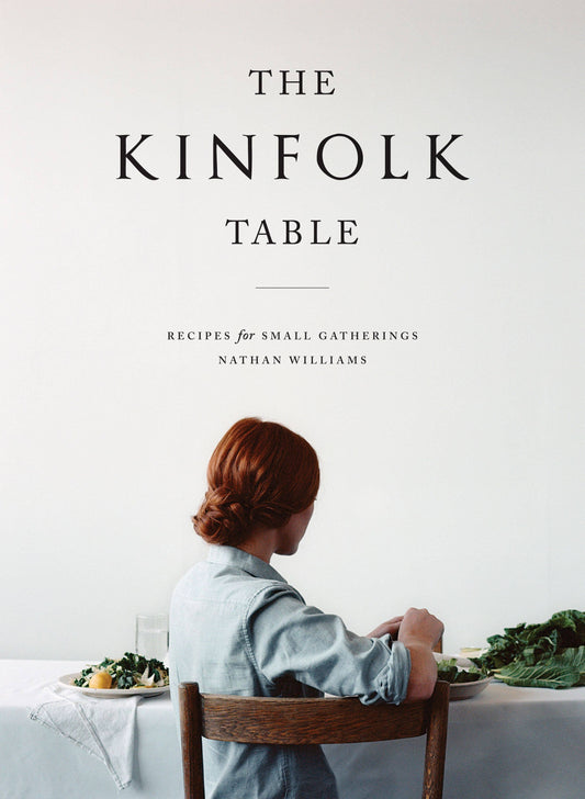 Close-up of The Kinfolk Table cover, Recipes for Small Gatherings, with a red-haired diner