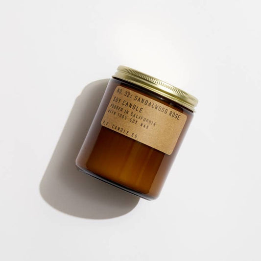 No. 32 Sandalwood Rose Soy candle in amber jar with craft label and brass lid.