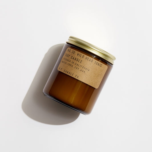 No. 36 Wild Herb Tonic Soy candle in amber jar with craft label and brass lid.