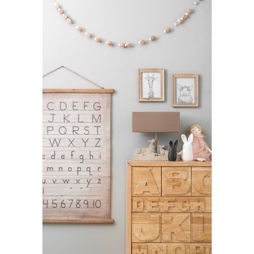 Vintage alphabet canvas wood scroll and jute hanger in child's room.