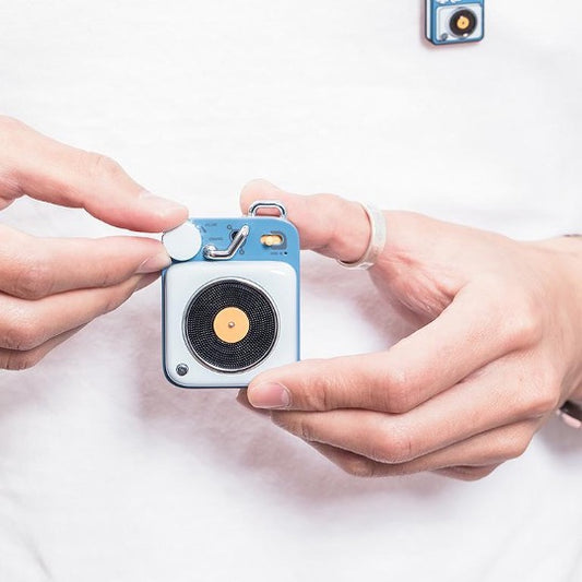 Berry blue button speaker hand held