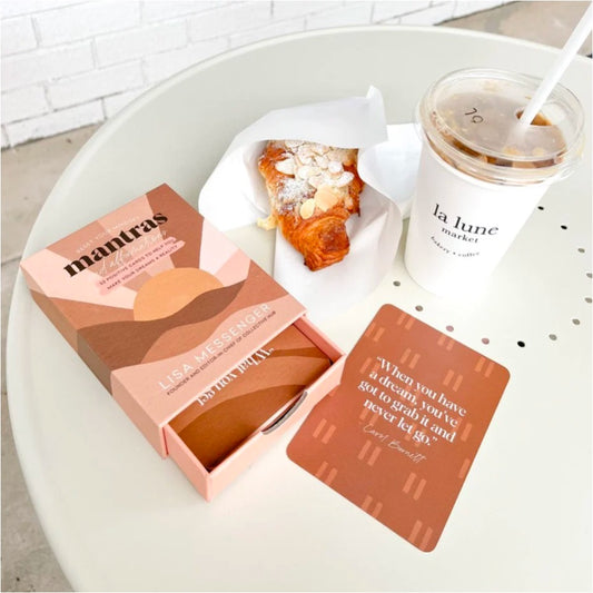 box cards with drawer pulled out on table next to croissant and drink.