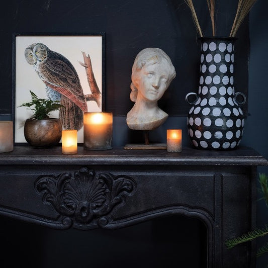 black fireplace with decorative objects on mantel