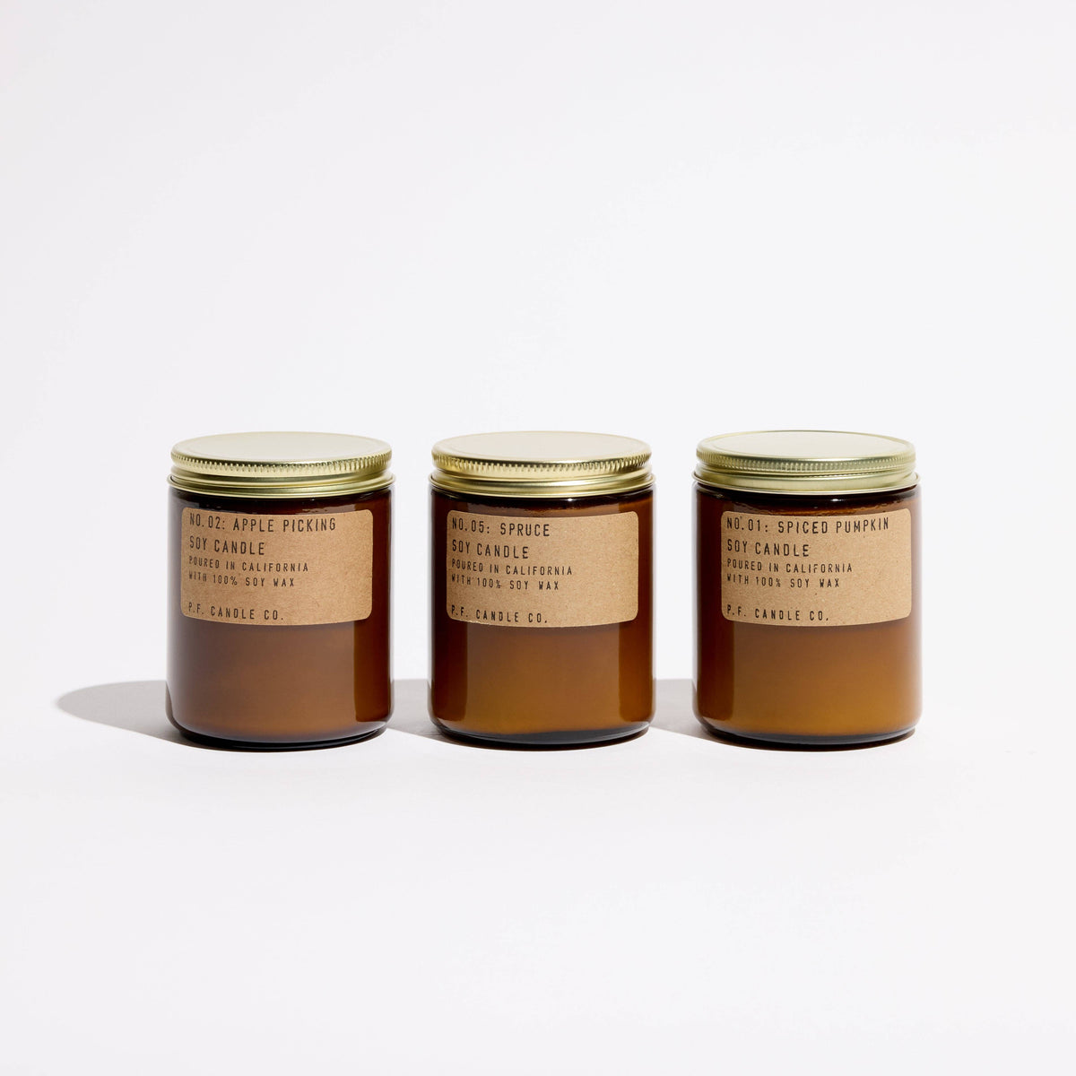 Fall Classics trio of lidded amber jar candles: Apple Picking, Spruce, and Spiced Pumpkin