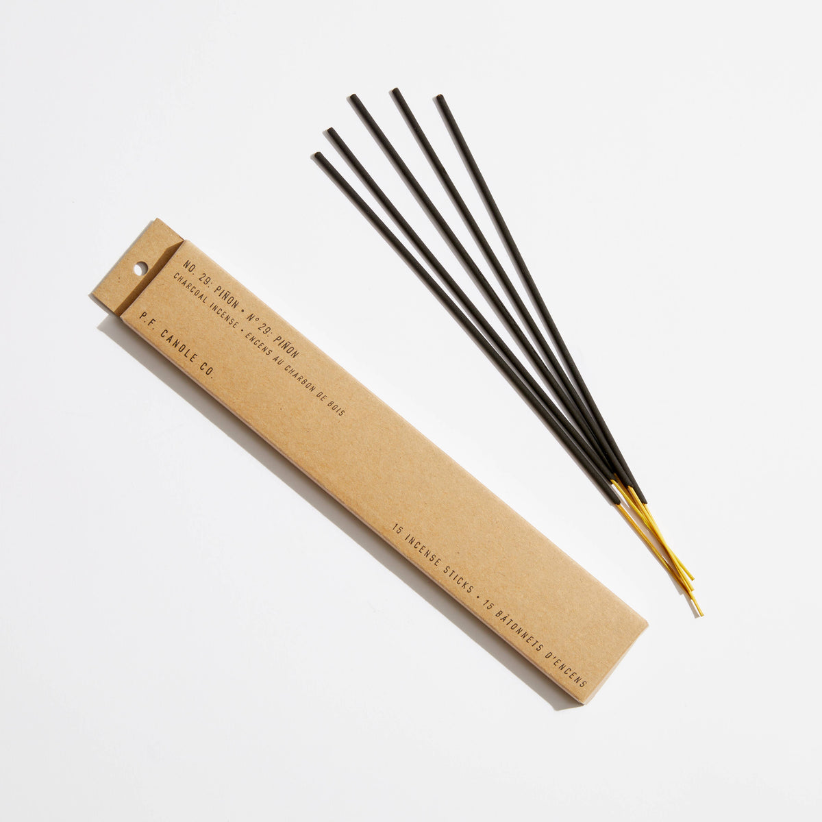 Piñon incense sticks, five black sticks with yellow tips beside their slim kraft box labeled No. 29 Piñon