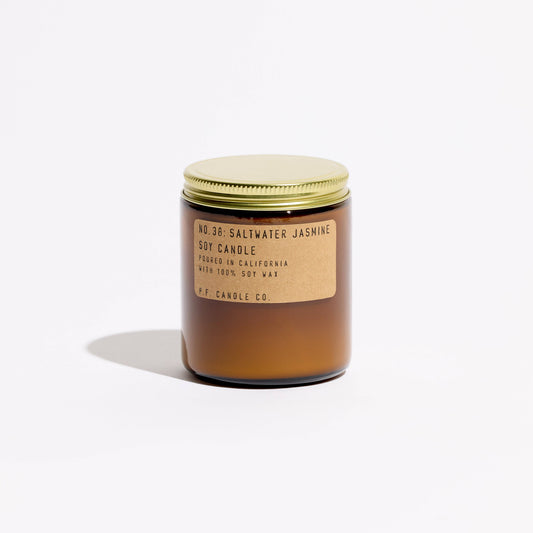 Saltwater Jasmine soy candle in an amber glass jar with gold lid and kraft label reading No. 38, front view
