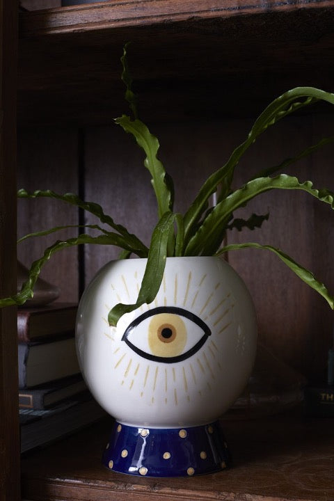 Blue and white pot with image of one eye.