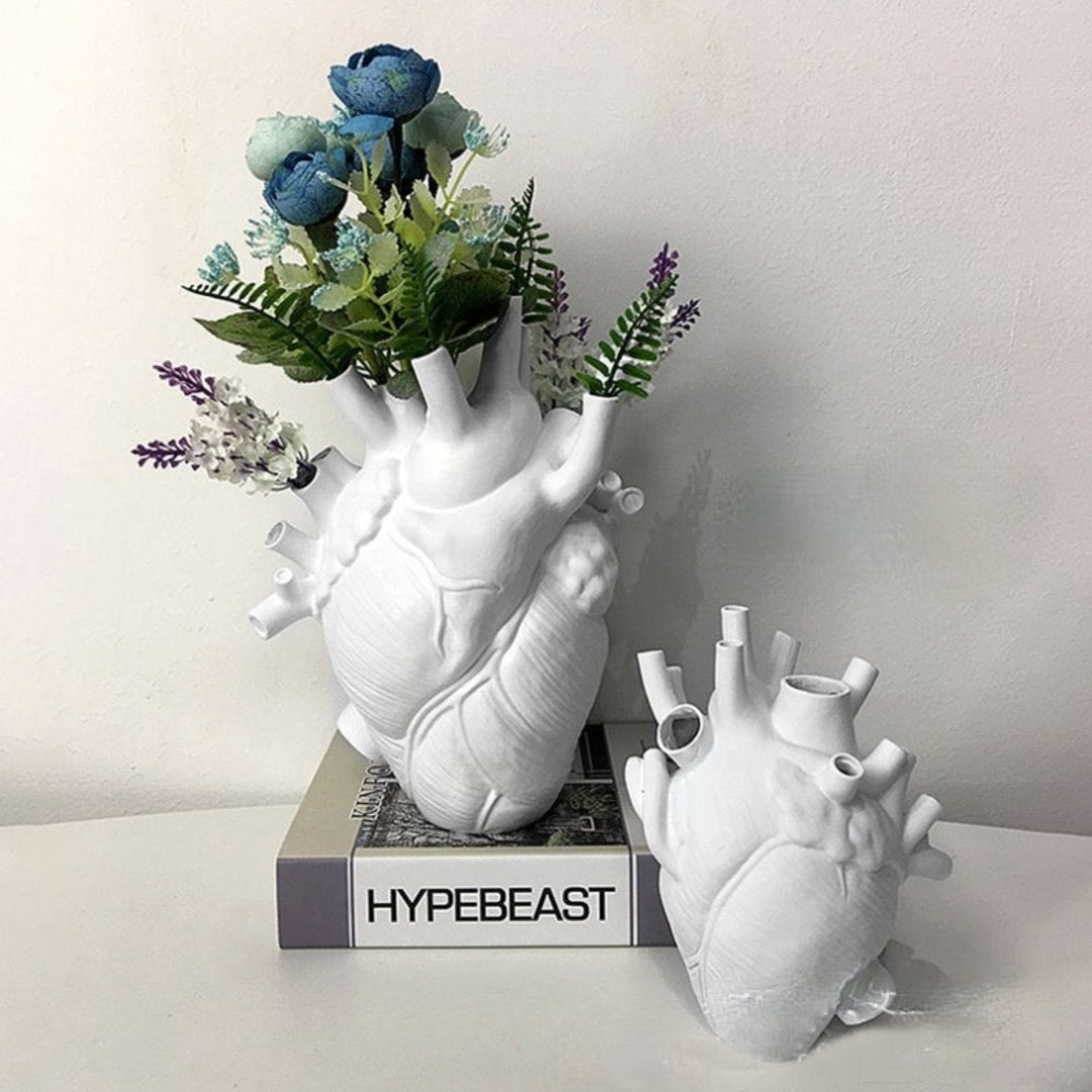 Set of anatomical heart vases in white with dried floral.