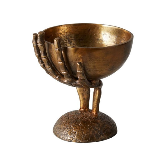 Metal skeleton hand holding bowl in brass finish.