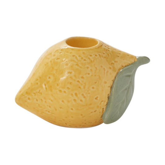 Lemon-shaped ceramic taper candleholder in textured yellow glaze with a sage green leaf