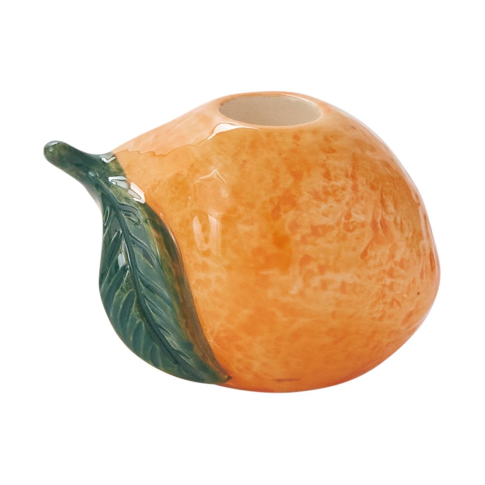 Orange-shaped ceramic taper candleholder in textured orange glaze with a sculpted green leaf