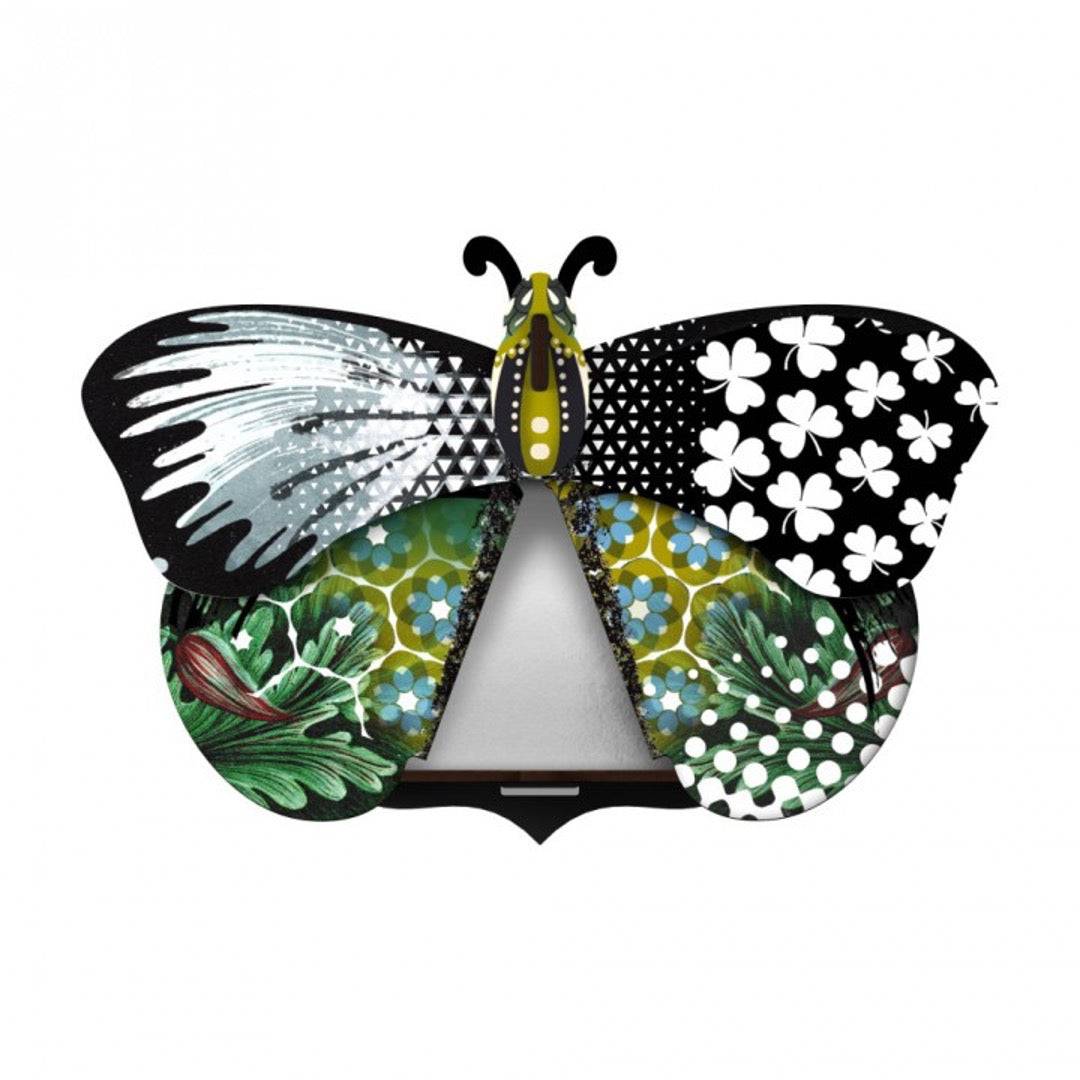 Aida butterfly wall cabinet wings open with mirror inside, with collage of patterns in green, black, and blue