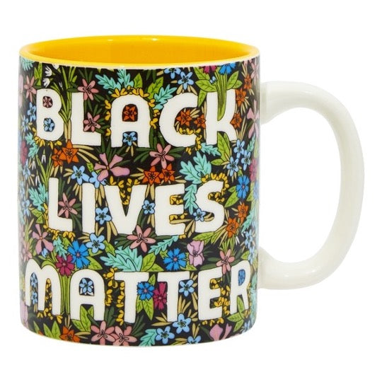 Black Lives Matter mug with colorful wildflowers pattern, yellow color inside mug. 