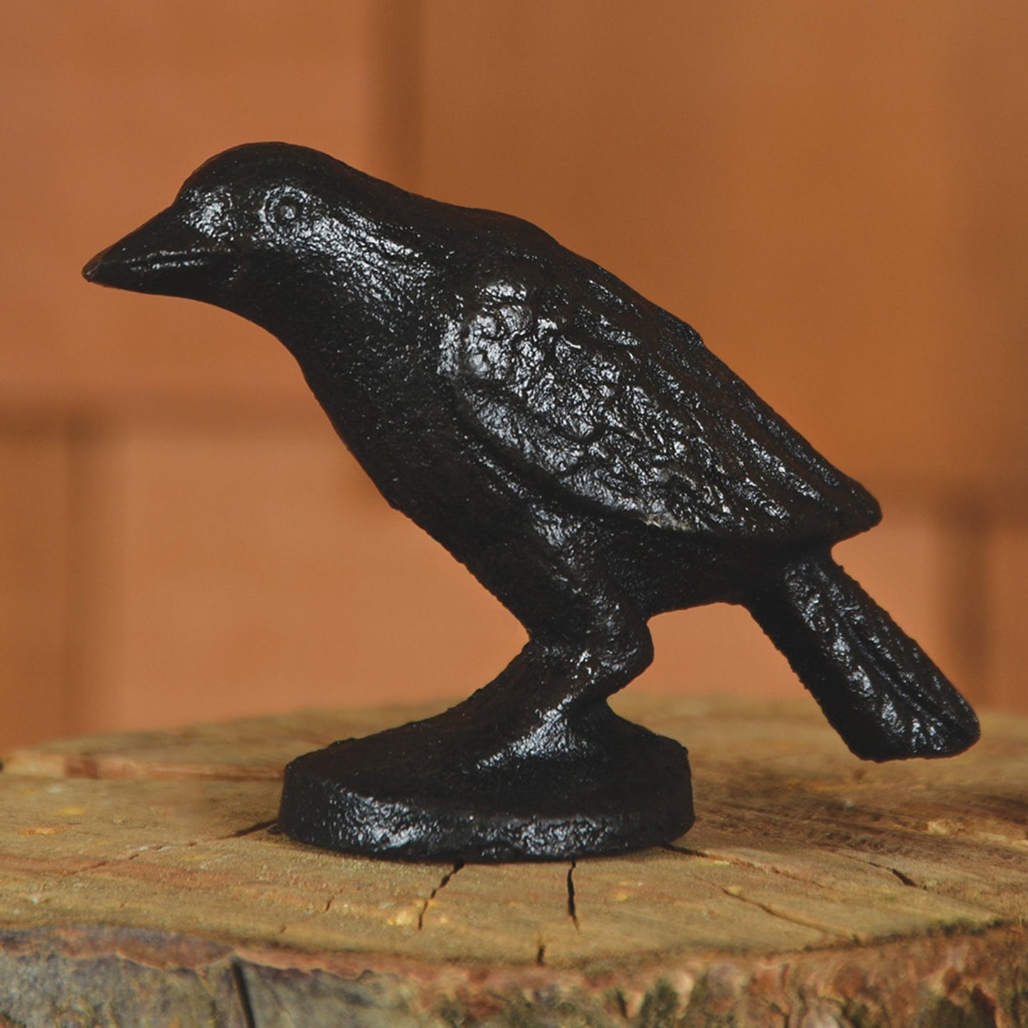 cast iron black crow on wooden block
