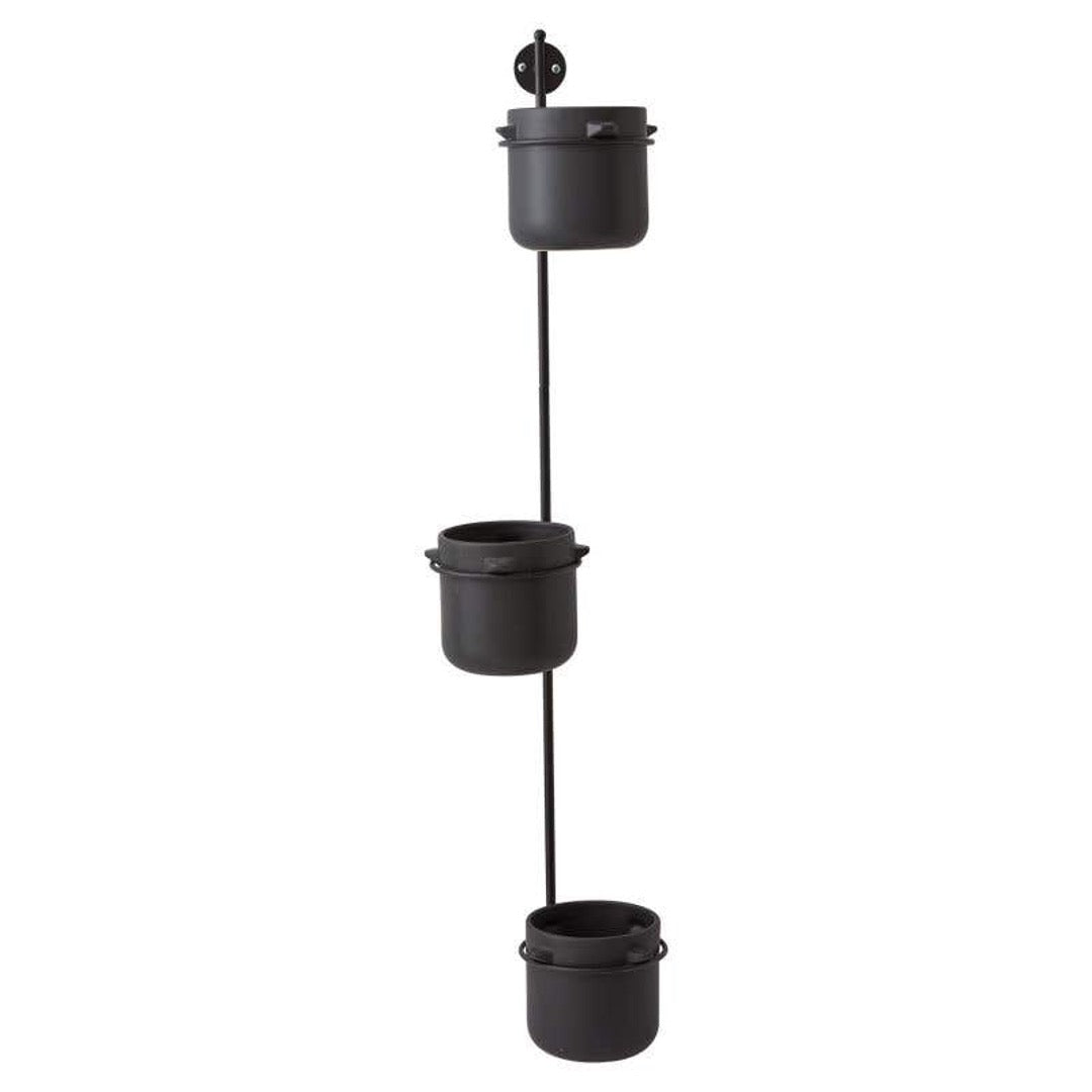 Hanging pot holder with three black pots.