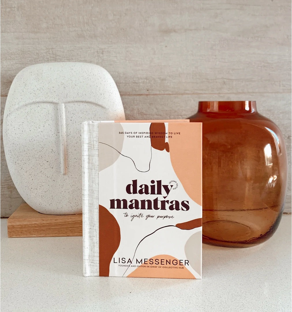 Daily mantras book in front of vases