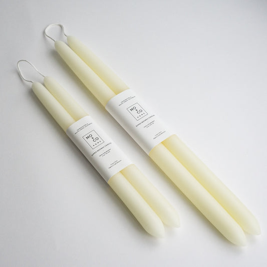 Pair of 10 inch and 14 inch dipped beeswax taper candles in natural white.