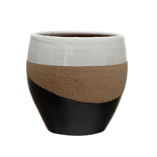 Multi-colored pot, white top, sand middle, and wavy black base