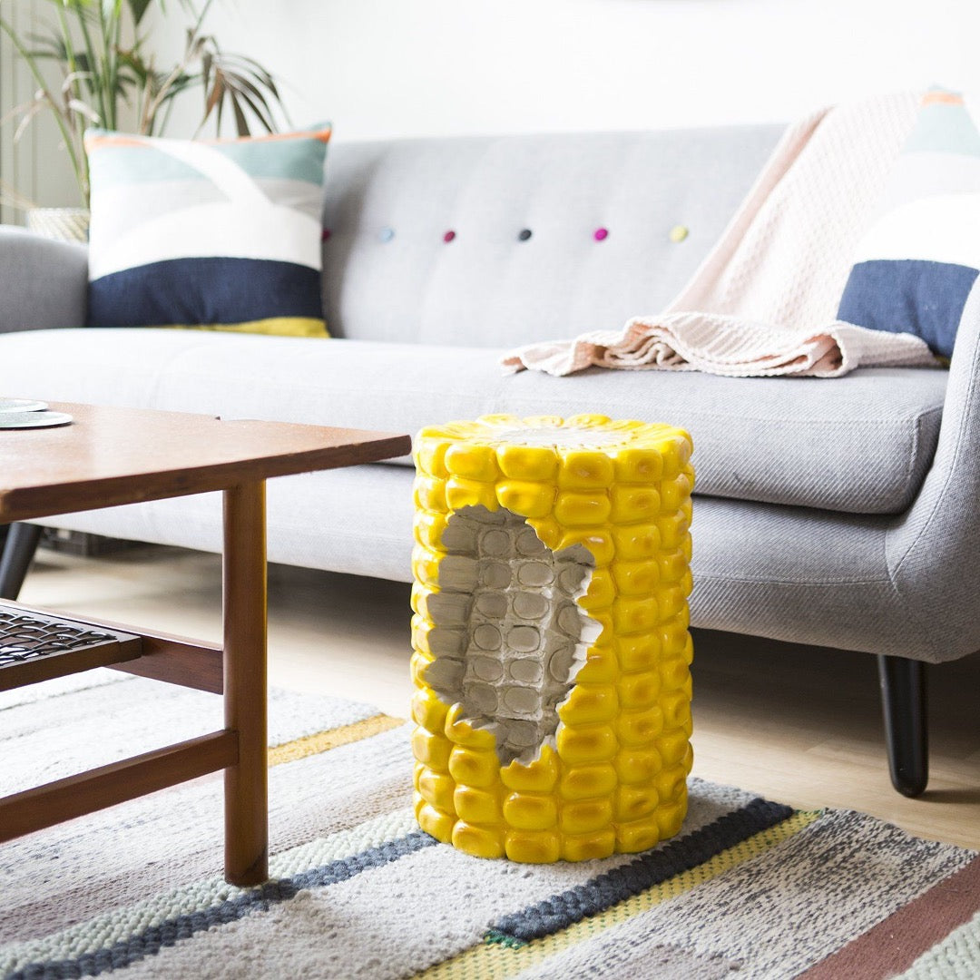 Oversize corn stool with section bitten out.  In living room setting. 