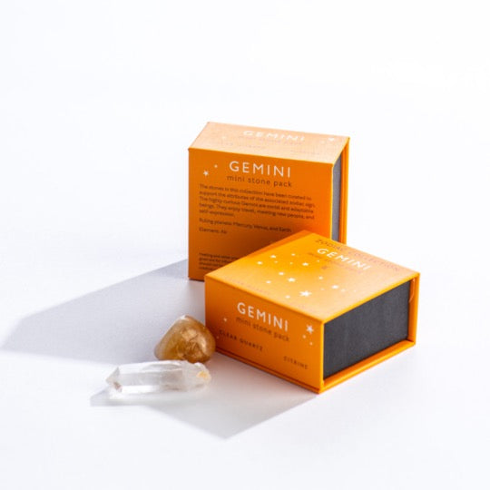 Gemini mini stone pack text on orange boxes with Gemini constellation pattern. Clear quartz and polished citrine stones in front. 