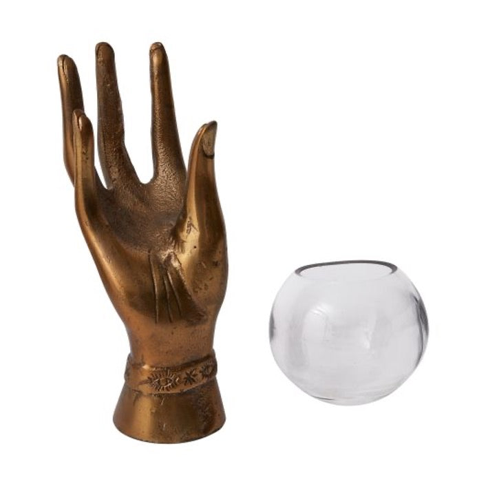 Metal hand in aged brass with  a glass round bowl.