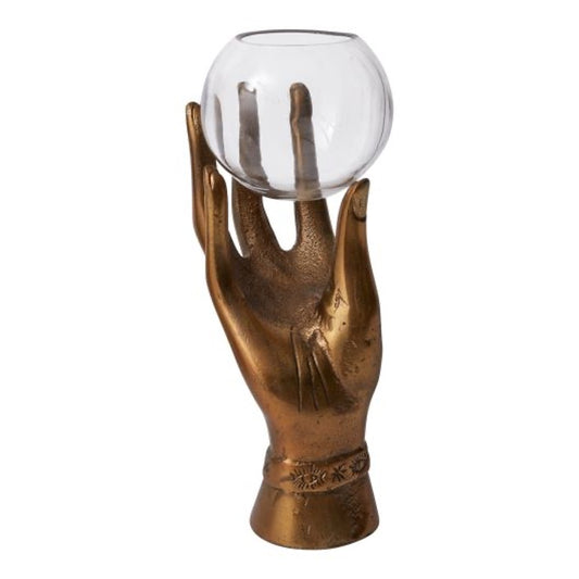 Metal hand in aged brass holding a glass round bowl.