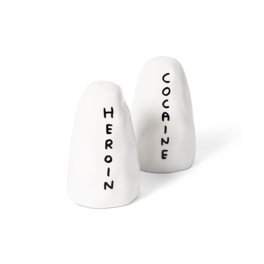 Abstract salt and pepper shakers in white with black text - heroin and cocaine