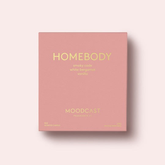 Homebody Candle in blush color box with gold text.