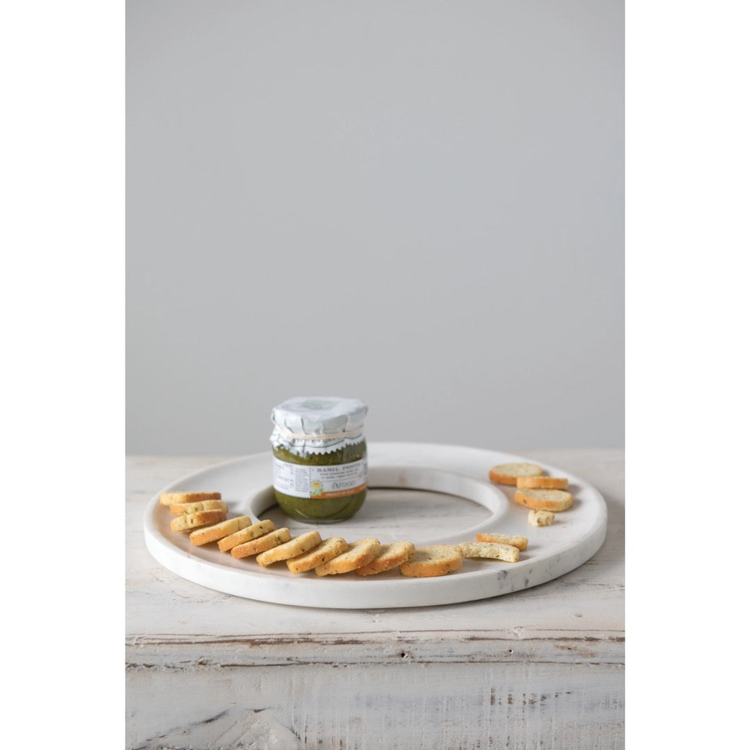 White marble serving tray with mini bread slices.