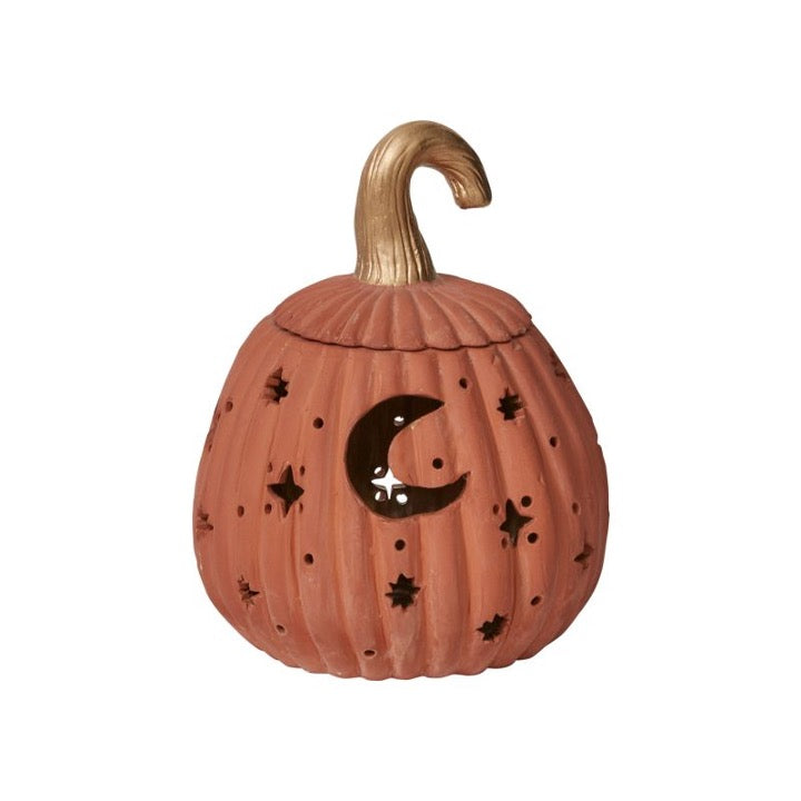 Ceramic pumpkin with cutout moon and stars.