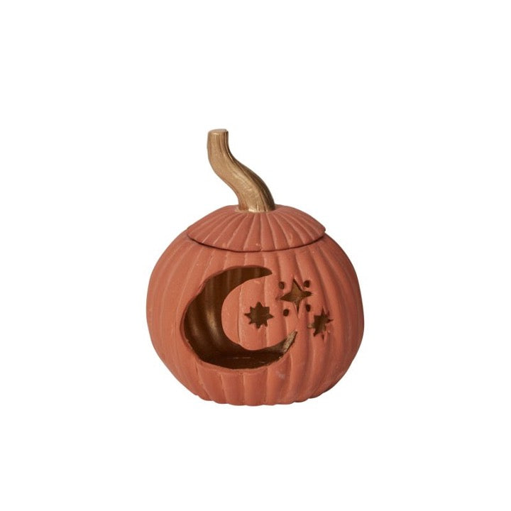 Ceramic pumpkin with cutout moon and stars.