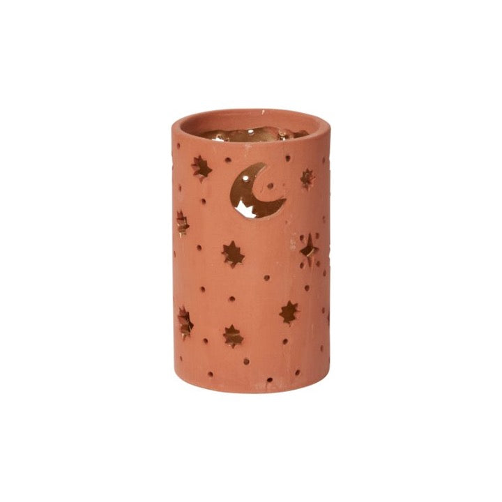 Ceramic votive with cutout moon and stars.