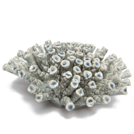 Ceramic sea coral in light blue, side view.