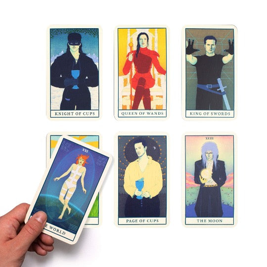 Assorted movie tarot cards with hand holding 1 card