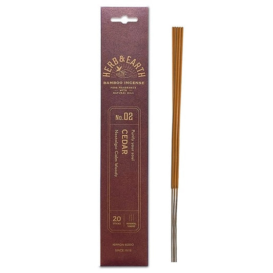 burgundy package with gold text and three incense sticks on right.