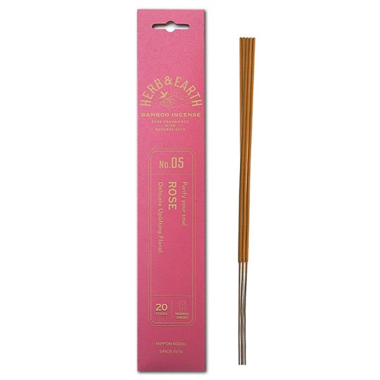 rose color package with gold text and three incense sticks on right.