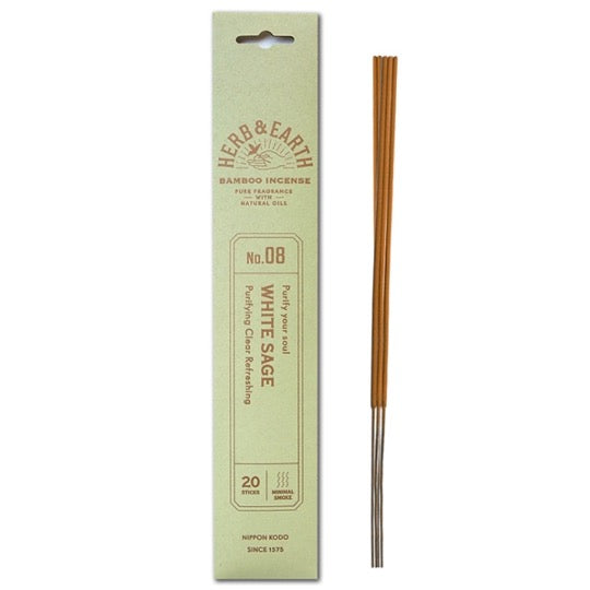 mint color package with gold text and three incense sticks on right.