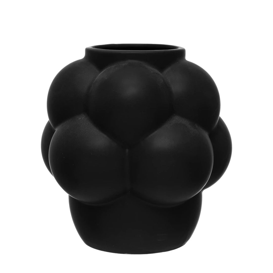 Abstract black vase in clusters of raised dots. 
