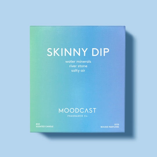 Skinny Dip candle in blue box.