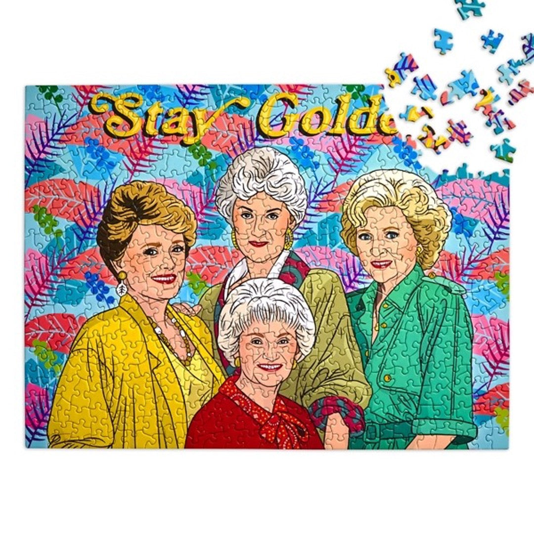 Golden Girls puzzle, multi-color palm leaves in background with text Stay Golden