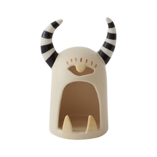 Monster tealight holder with one eye and black and white striped horns. 