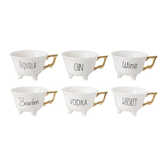 Six tea cups with gold handles.  Each tea cup has black text with Wine, Vodka, Gin, Tequila, Whiskey, or Bourbon on side.