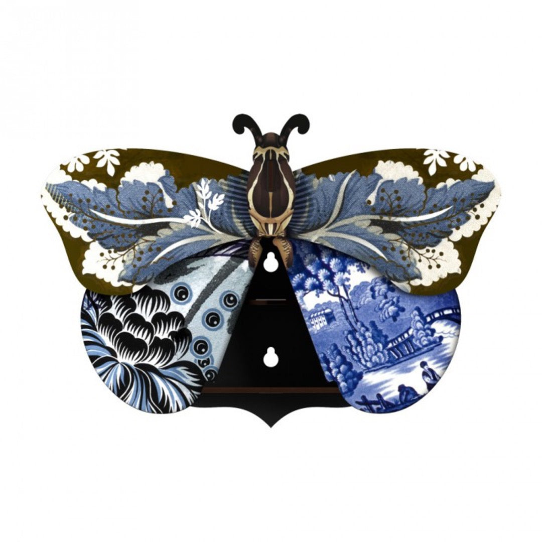 Tosca butterfly wall cabinet wings open with 2 holes for hanging, with a collage of blue and black patterns