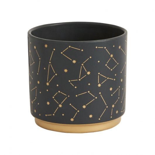 Black pot with star constellation in gold.