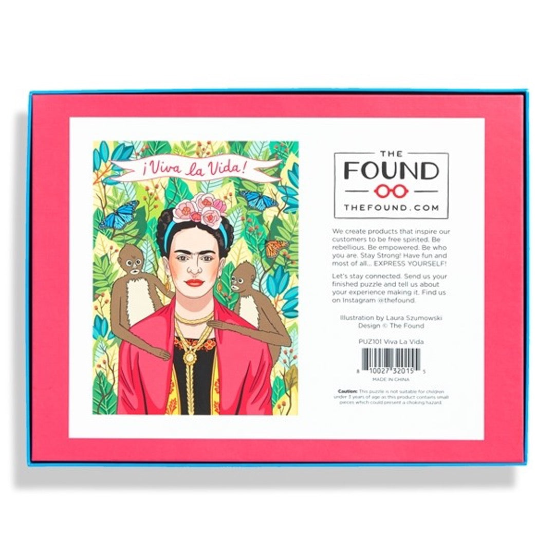 Back box of 500 piece jigsaw puzzle, Frida Kahlo in jungle with two monkeys on each side of her shoulder with Viva La Vida banner on top